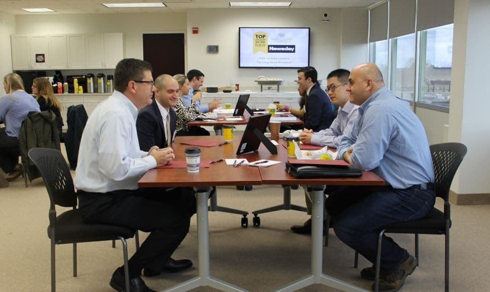 Professionals Sitting At A Table And Having A Discussion