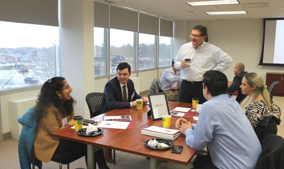 A Group Of Professionals Having A Discussion