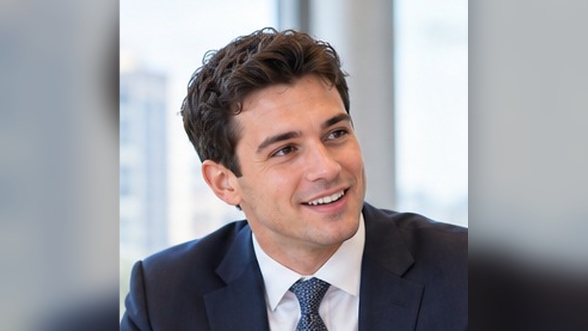 Business Development For Young Lawyers: Smiling Young Associate In A Navy Suit At A Law Firm
